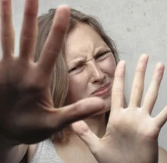 A candidate wincing and holding up both hands, put off by a generic screening bot.